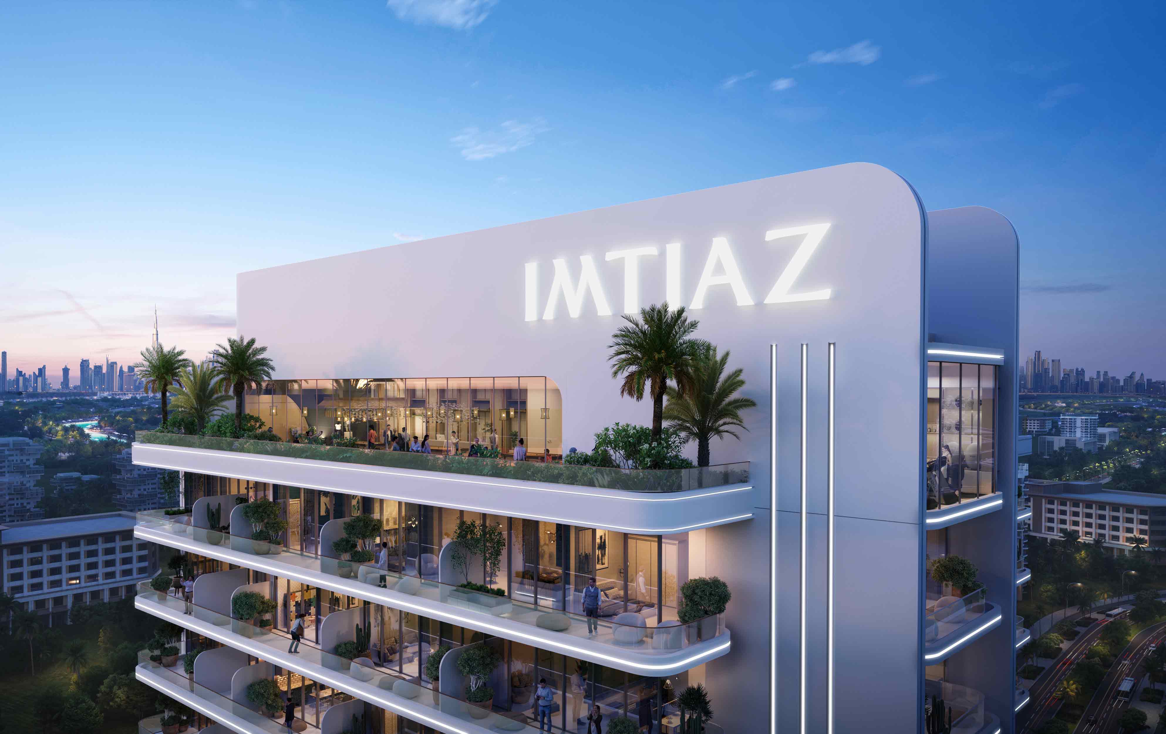 Le Blanc A modern building with the name "IMTIAZ," featuring terraces and palm trees against a city skyline at dusk.
